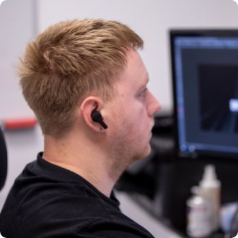 Web developer at Design 380 working on computer