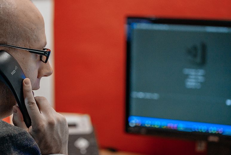 Technical Director at Design 380 in front of computer